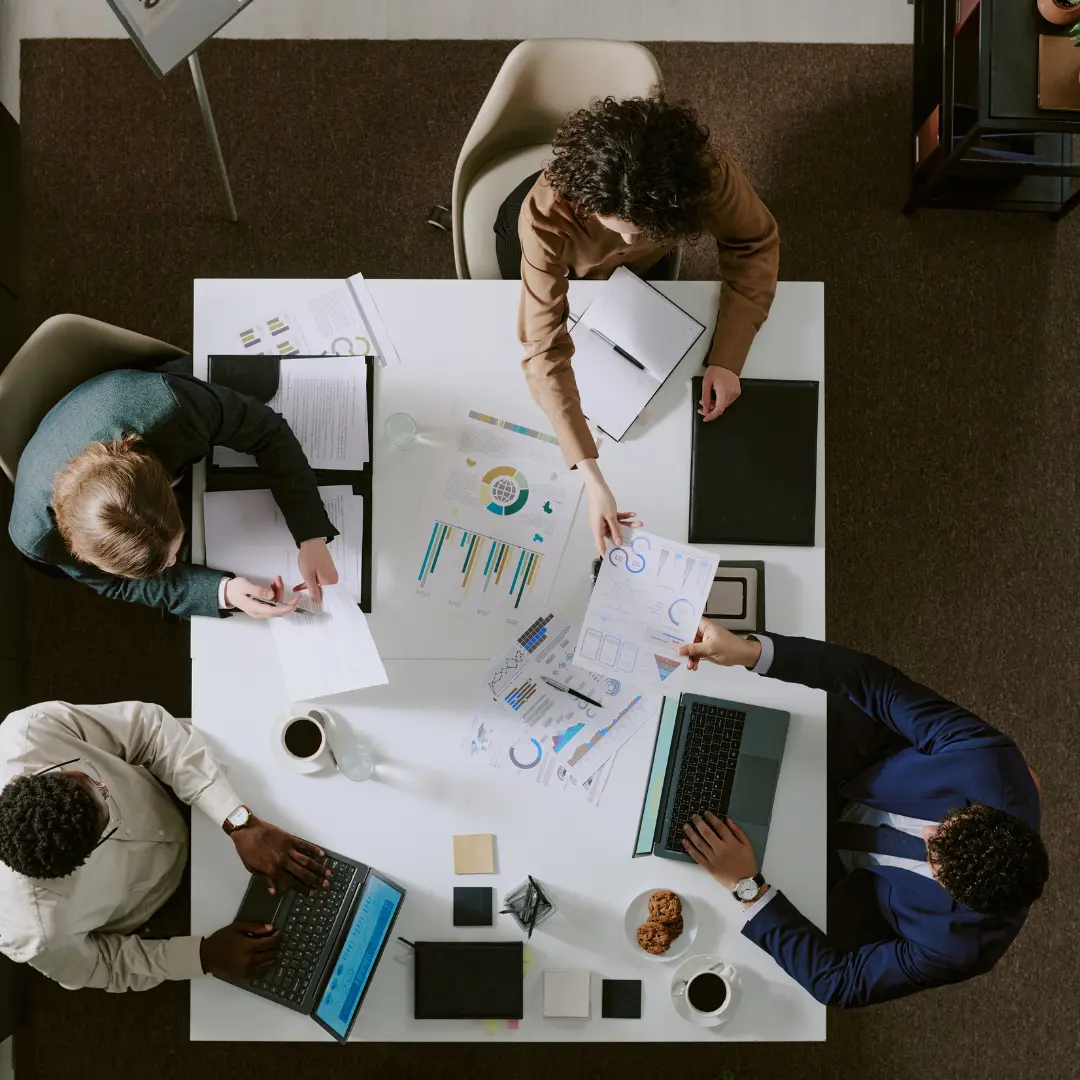 Sustainability and Procurement Review Business professionals reviewing sustainability and procurement documents during an ESG meeting.